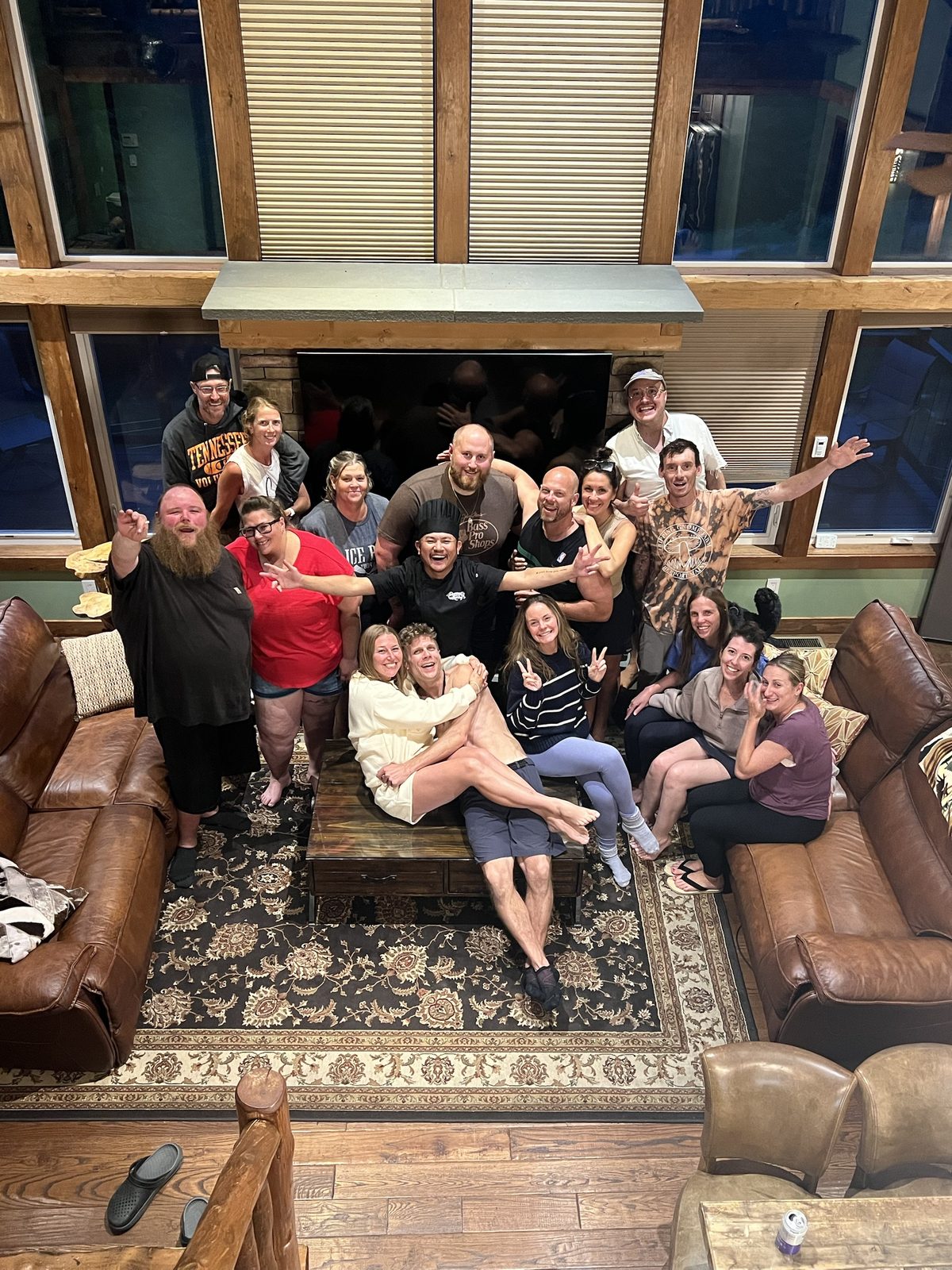 Large group of happy private hibachi party guests indoors by the fireplace