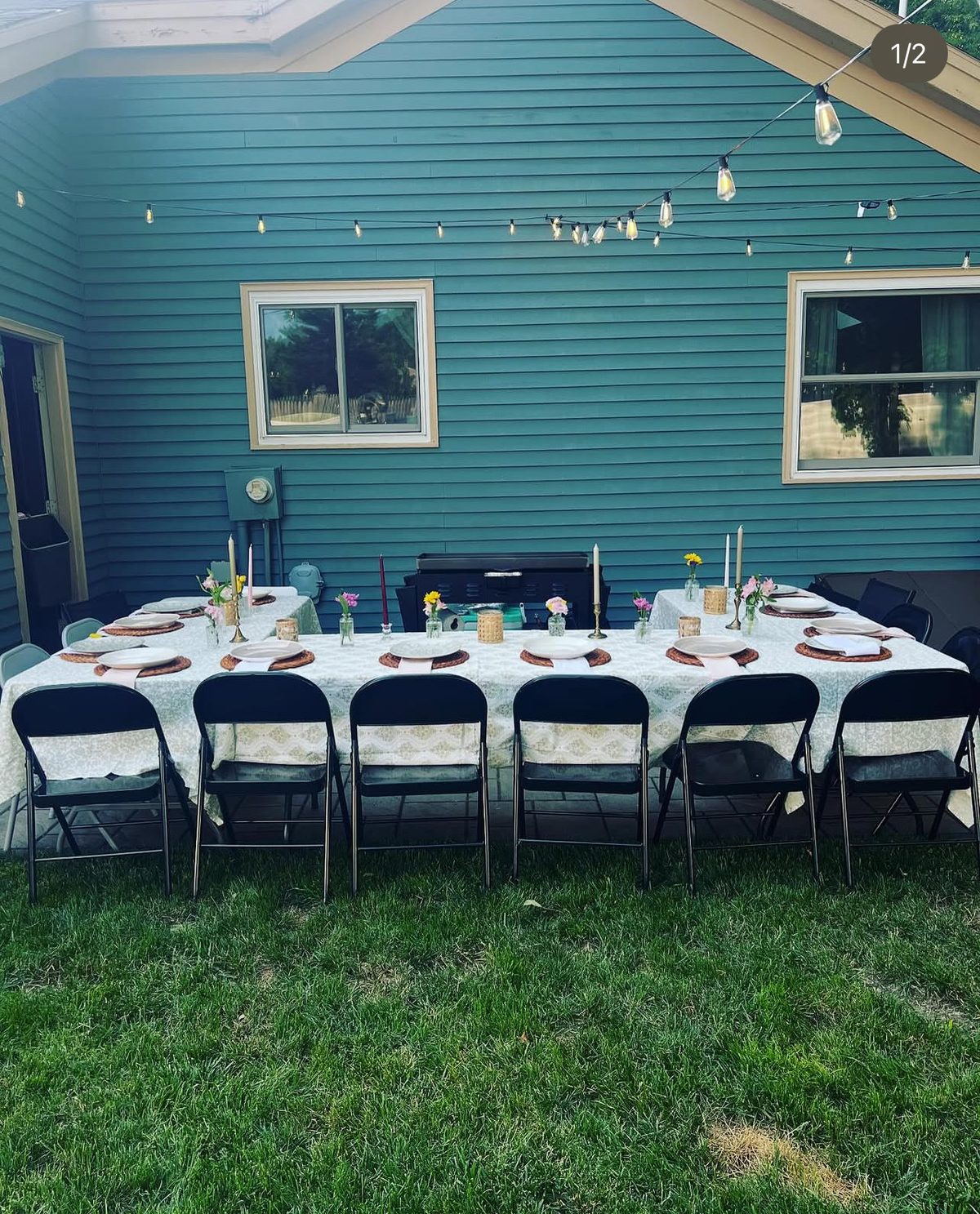 A private event table set and ready for guests, string lights overhead
